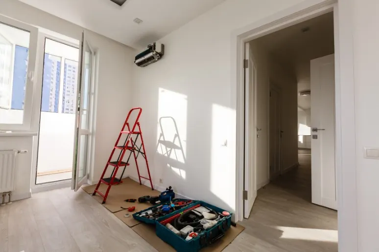 Room under renovation with a split aircon being fitted